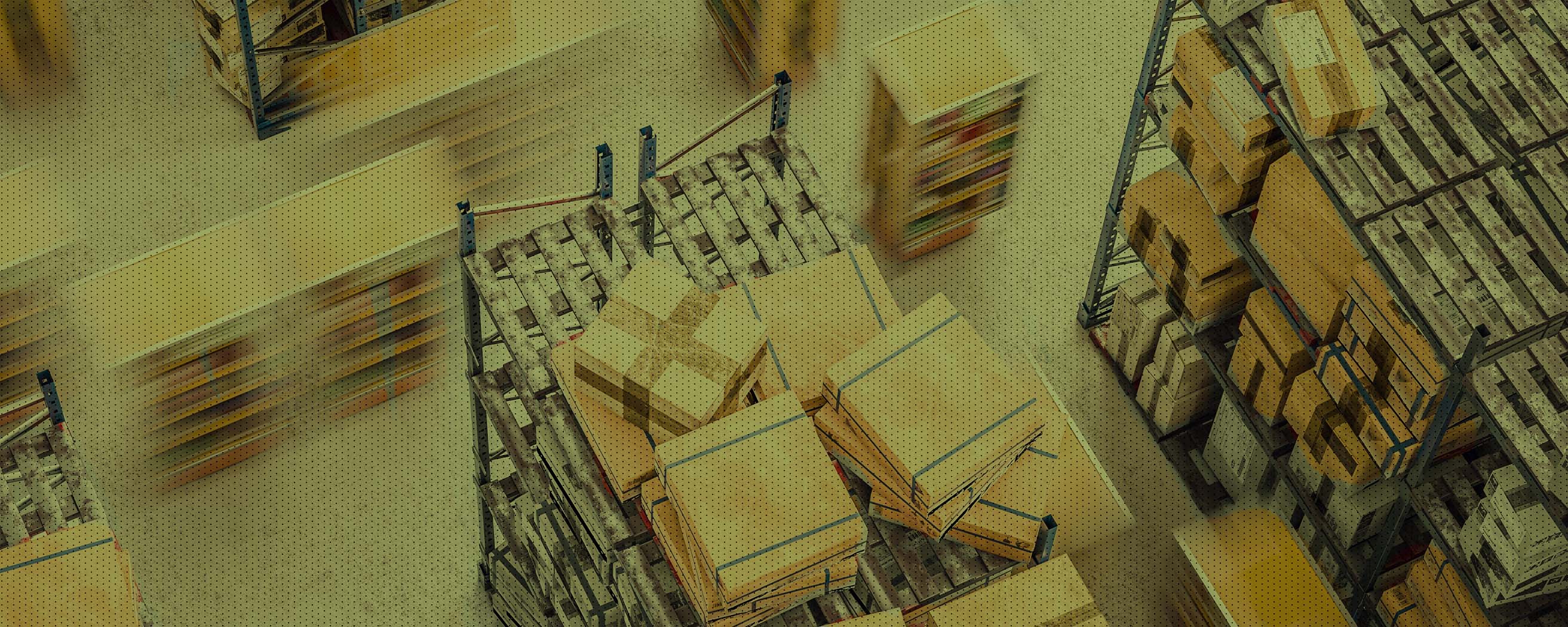 An overhead view of a warehouse filled with shelves and pallets stacked with cardboard boxes, capturing the movement and organization of logistics operations.