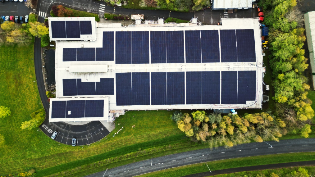 Aerial view of the Plexus Kelso site, featuring solar panels on the roof and recycling bins visible to the left of the building.